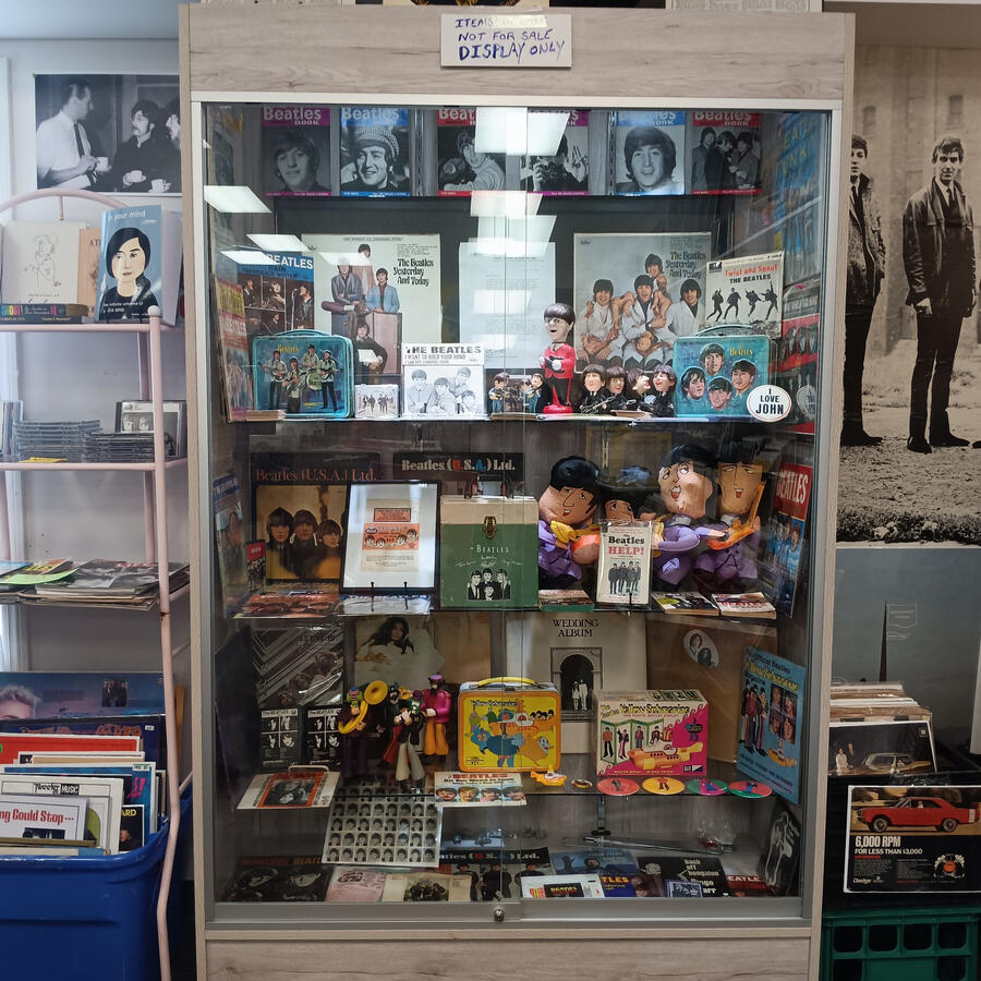 Display case filled with Beatles memorabilia.
